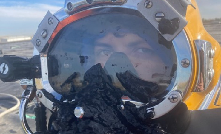 Commercial diver performing fire water pond dredging”